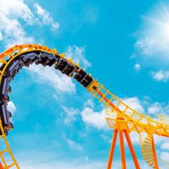 A roller coaster with blue sky and clouds.